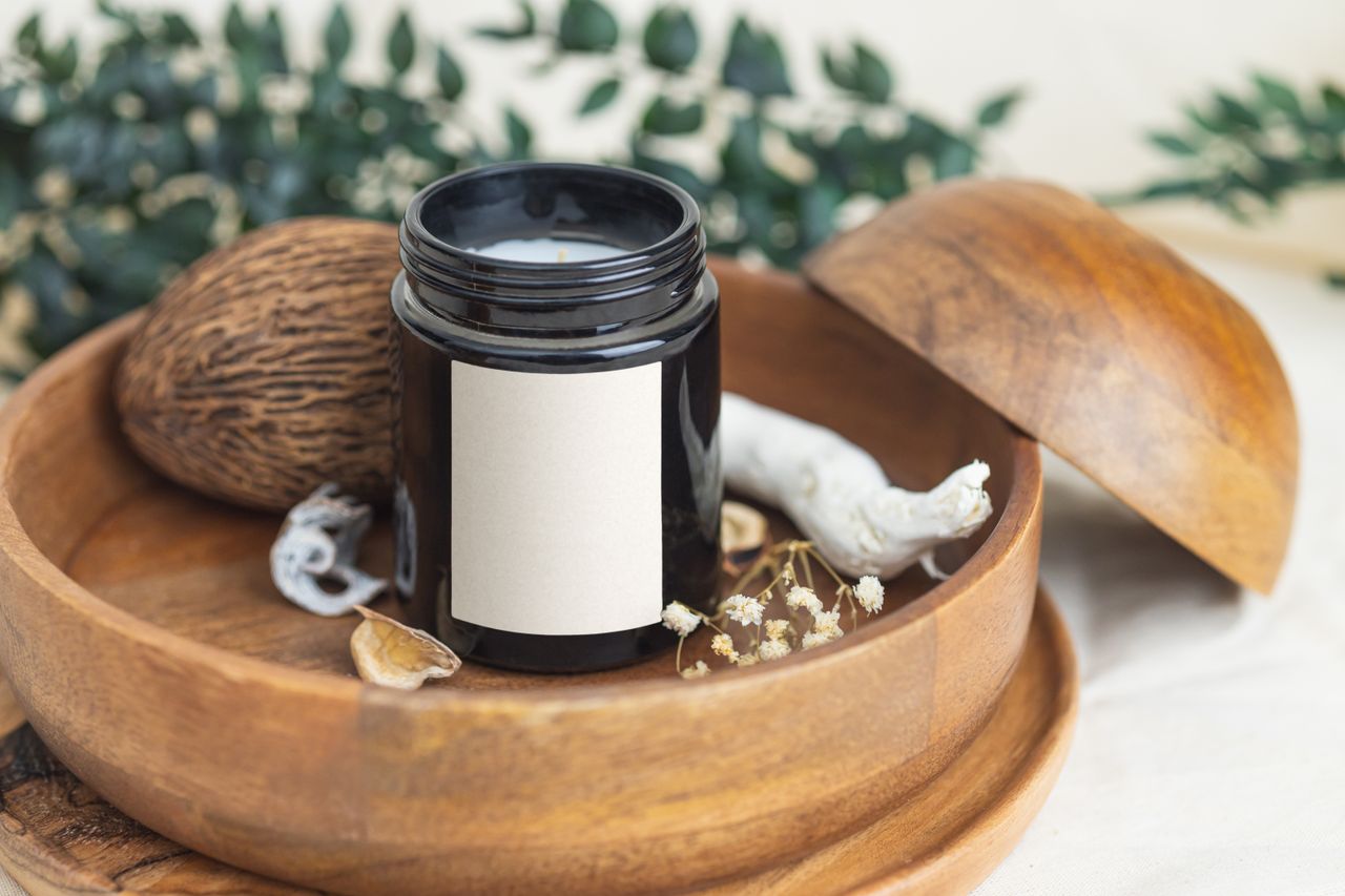 services-03 Elegant scented candle in a wooden bowl with aromatic elements, ideal for relaxation.