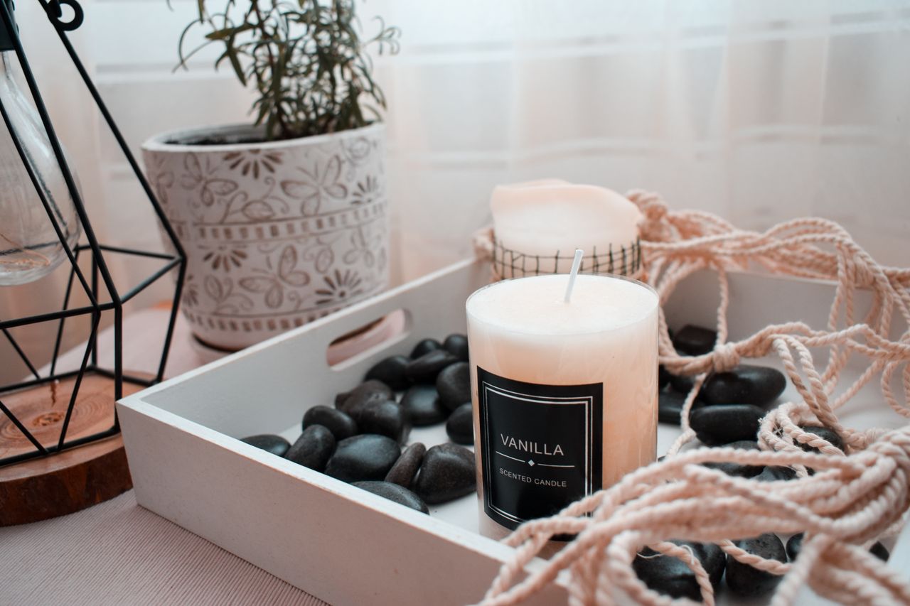 experience-img Stylish indoor décor with a vanilla scented candle on a wooden tray.
