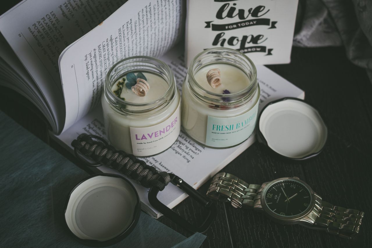 who-we-are-img A cozy scene featuring aromatic candles, an open book, and a watch, perfect for relaxation.