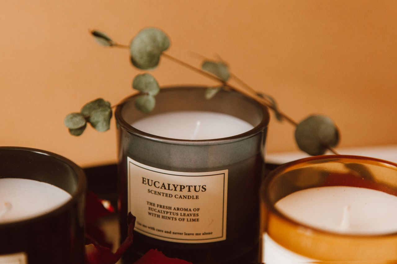 services-02 Close-up of eucalyptus scented candles with dried eucalyptus leaves, creating a warm aromatic ambiance.